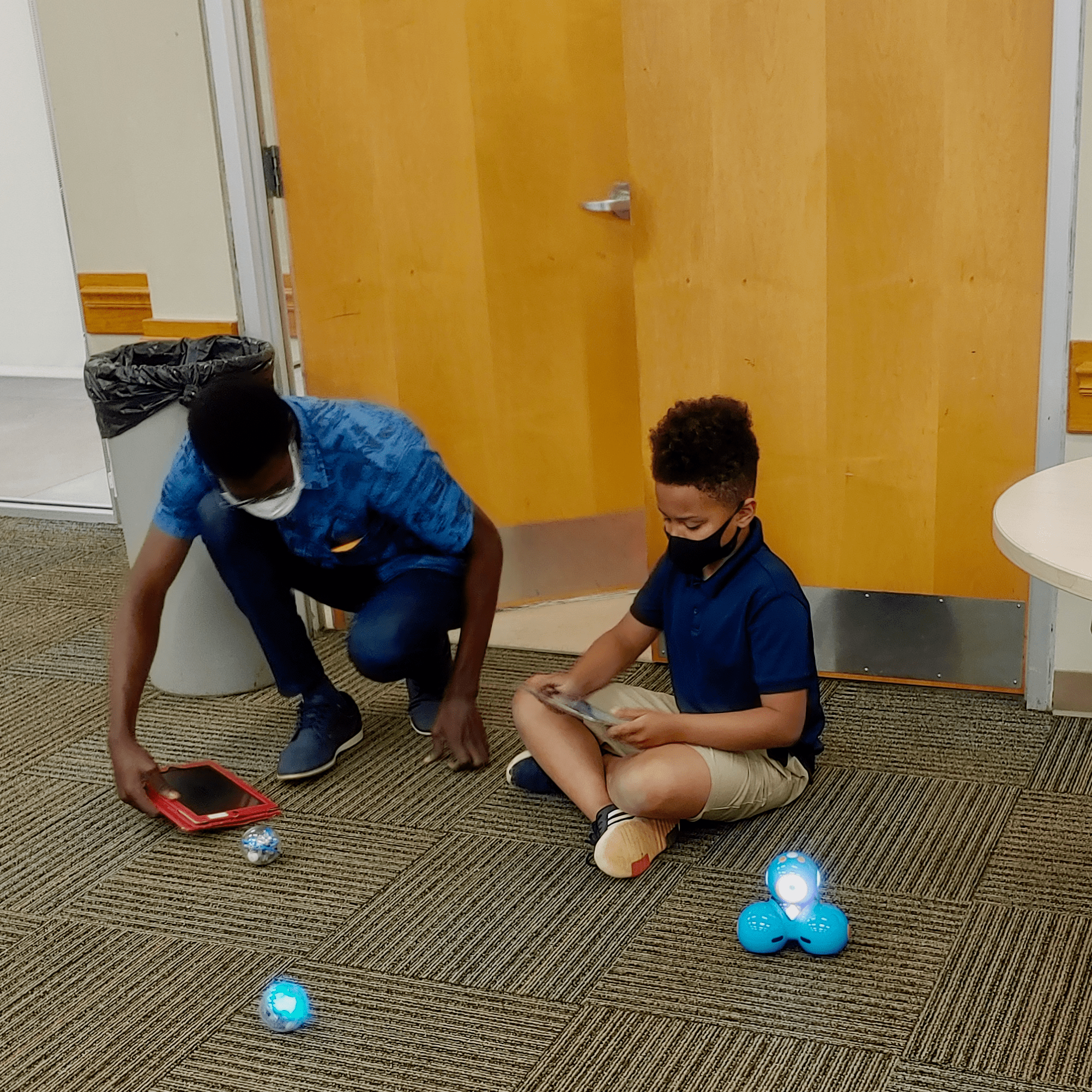 researcher and child playing robots